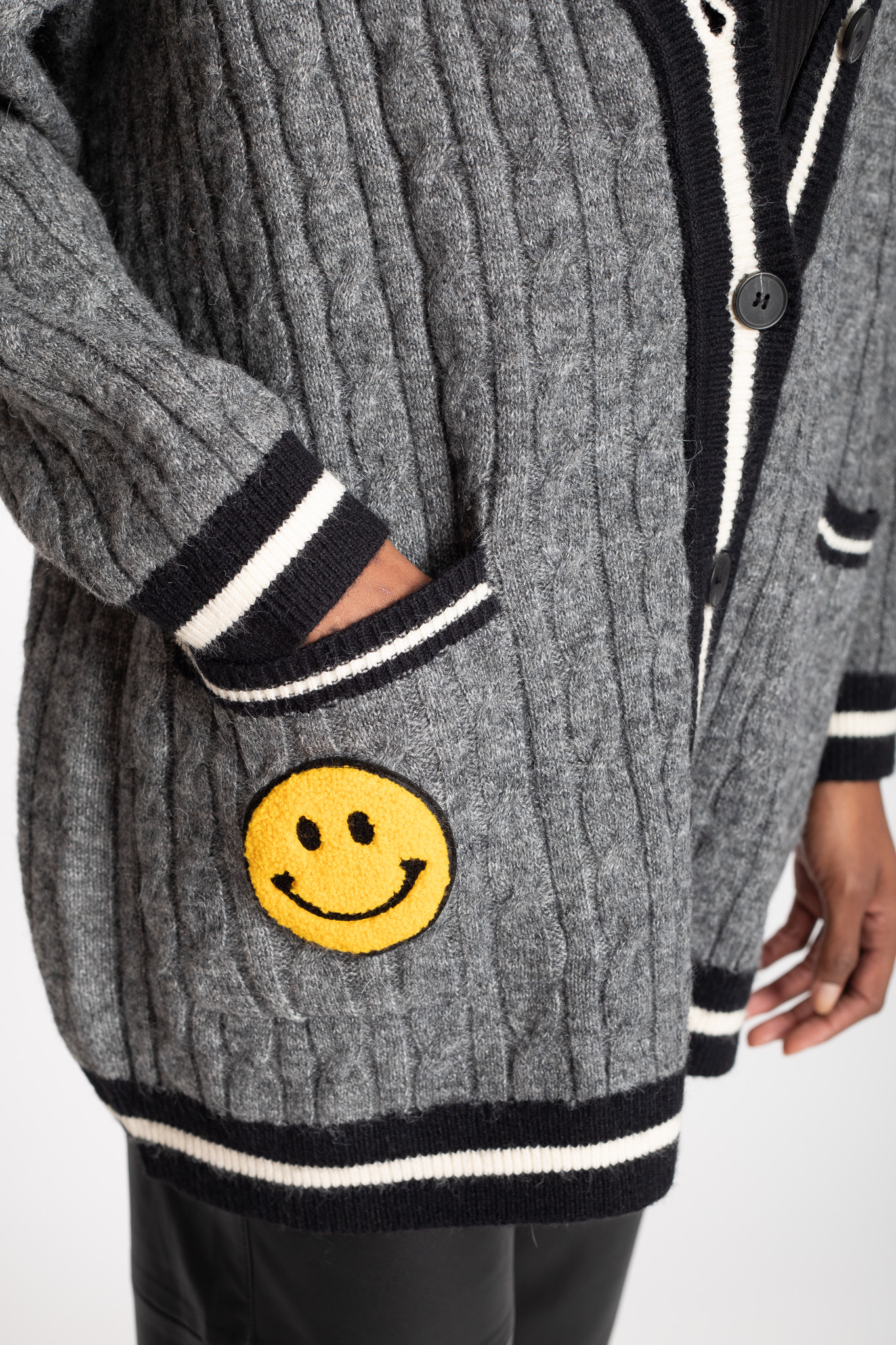 yellow smiley face grey cardigan