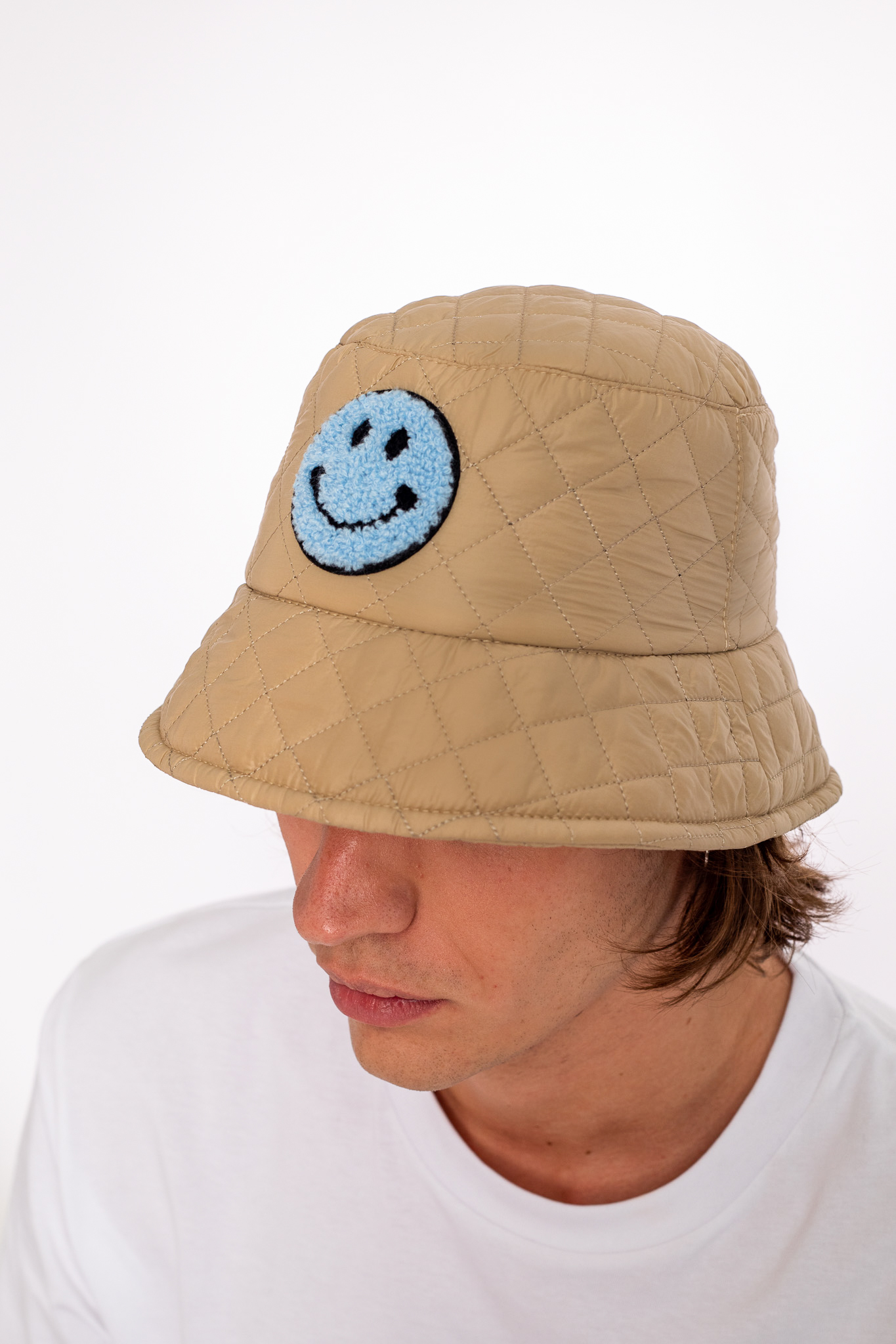 beige bucket hat with blue smily face